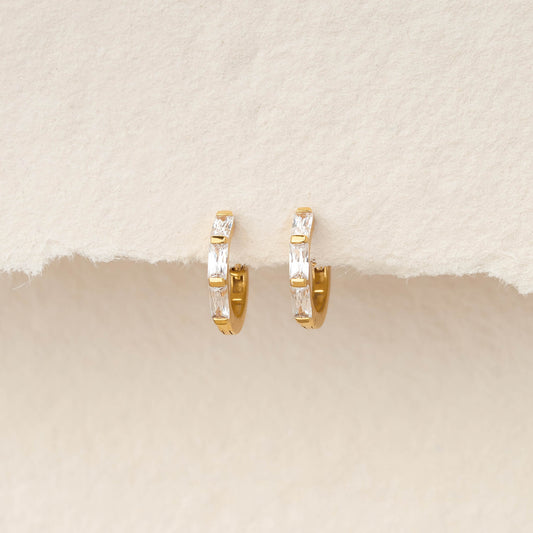 Pair of Gold Vermeil earrings set with baguette-cut gemstone, displayed hanging against a soft, textured ivory background.