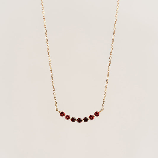 January Birthstone Necklace 14k Gold - Ombre Garnet with a delicate curved bar and gradient garnet stones on a gold chain
