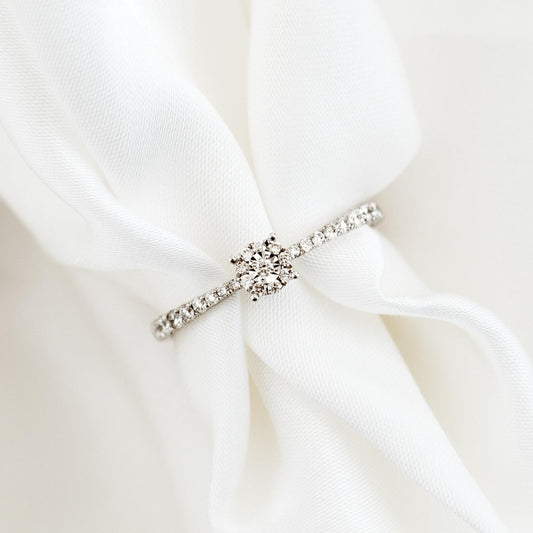 Round Cluster Diamond Ring White Gold - Brisa with pavé band and round cluster diamonds on white fabric background