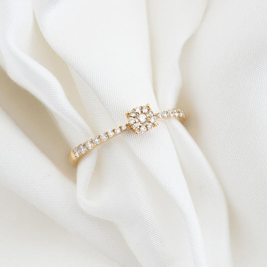 Round Cluster Diamond Ring 14k Gold - Brisa with pavé band and brilliant diamonds displayed on soft white fabric background