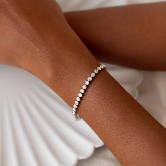 Half Diamond Tennis Bracelet 14k White Gold (1.8 - 2.0 ct tw) worn on wrist with white fabric background