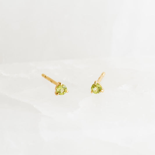 August Birthstone Stud Earrings 14k Gold - Olivine with small round olivine gemstones set in yellow gold studs on a white background