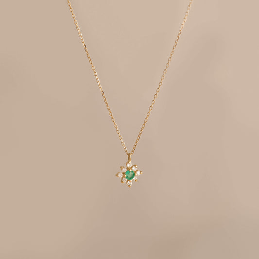 Emerald Flower Pendant Necklace 14k Gold - Inga featuring a delicate chain and emerald diamond flower pendant on beige background