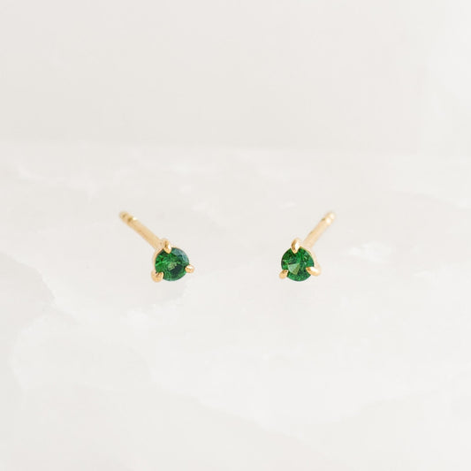 May Birthstone Stud Earrings 14k Gold - Tsavorite small green gemstones set in delicate three-prong yellow gold studs on white background