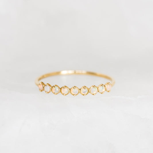 October Birthstone Ring 14k Gold - Opal with nine shimmering opal gemstones set in a delicate gold band on a white background