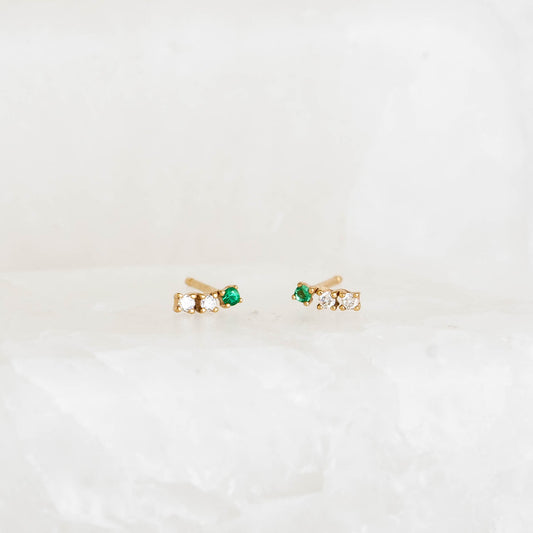 Emerald Bar Stud Earrings 14k Gold - Nerea with lab grown emeralds and diamonds on a soft white background