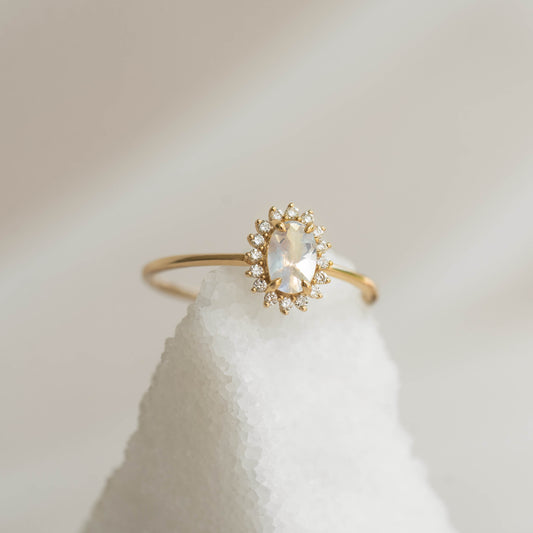 Sunburst Moonstone Halo Ring - Chiara with oval rainbow moonstone and diamond halo set in 14k yellow gold