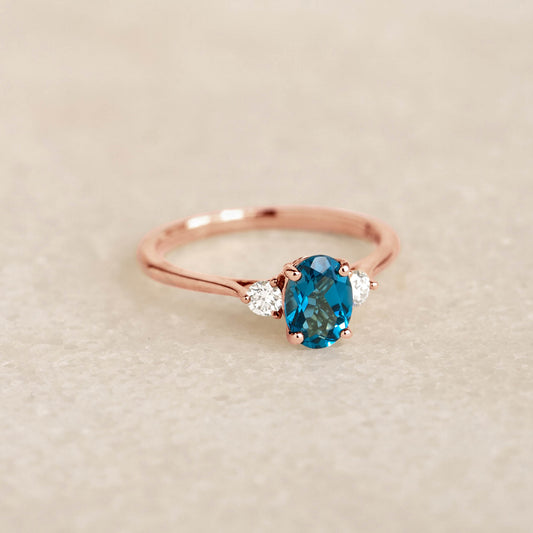 London Blue Topaz and Diamond Ring Rose Gold - Kindra with oval blue topaz and two side diamonds on rose gold band