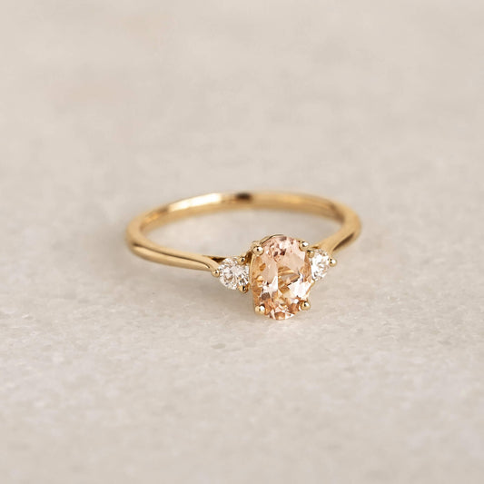 Morganite and Diamond Ring 14k Gold - Kindra with oval morganite and two diamonds on a tapered gold band on soft background