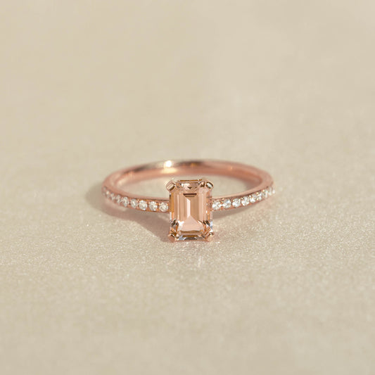 Baguette Morganite and Diamond Ring Rose Gold - Safiya with a rectangular morganite and pavé diamond band on beige background