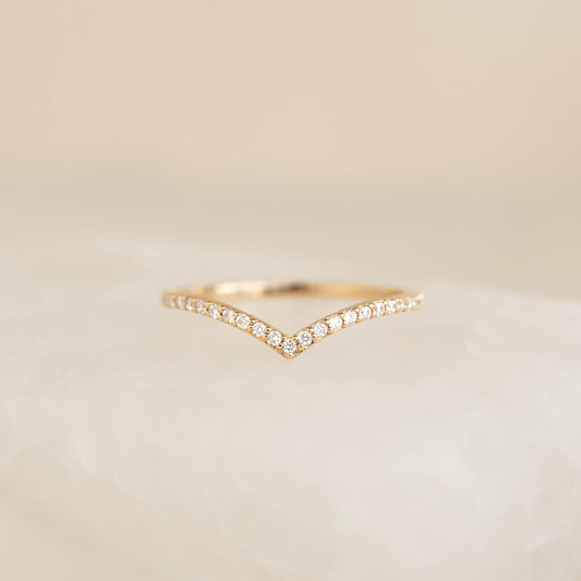 Diamond V Ring 14k Gold - Sanne with pavé set diamonds on a delicate chevron band on a soft neutral background