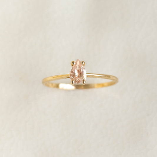 Close-up of Pear Shaped Morganite Ring 14k Gold - Martine with pear-cut gemstone on a delicate gold band on a neutral background