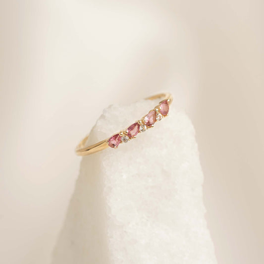 Minimalist July Birthstone Pear Ring 14k Gold - Pink Tourmaline and Diamond displayed on white textured stone