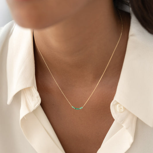 Close-up of a woman wearing the May Birthstone Necklace 14k Gold - Ombre Green Chalcedony with a delicate ombre gemstone curve on gold chain