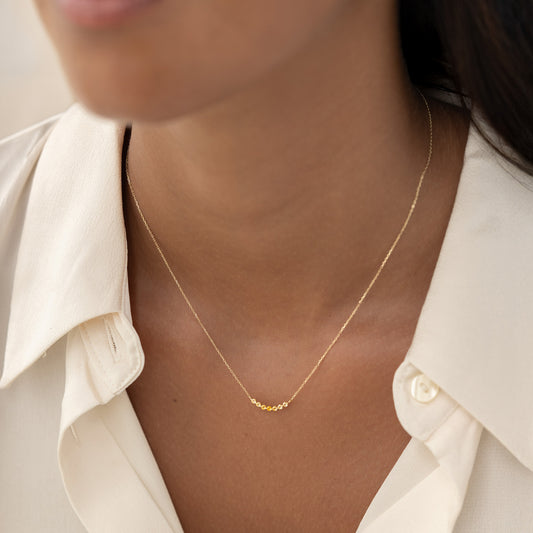 Close-up of a woman wearing the November Birthstone Necklace 14k Gold - Ombre Citrine with a delicate gold chain and gemstones