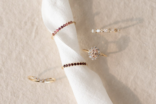 Jewelry including bracelets and a ring on a white fabric background