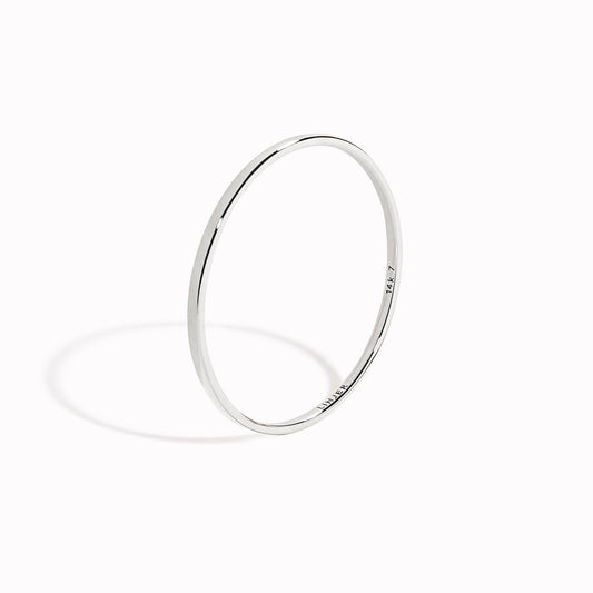 Thin White Gold Ring - Elin photographed on white background with soft shadow highlighting its minimal design
