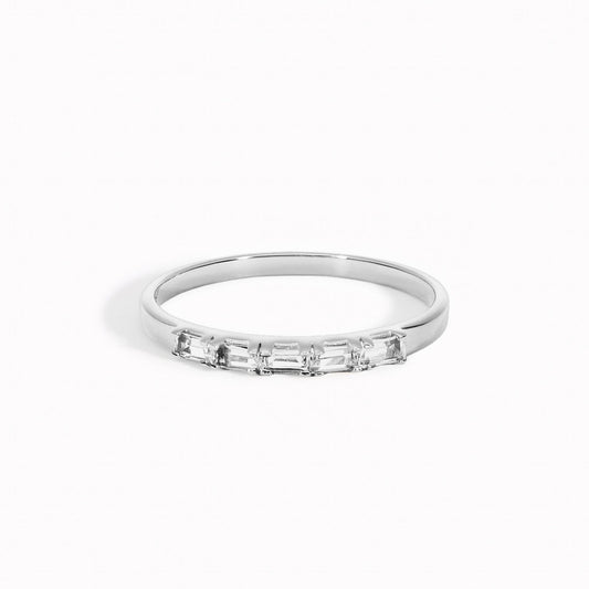 Baguette ring with white topaz gemstones set in a half-eternity silver band