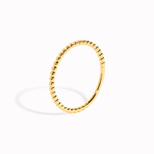 Gold stacking ring with beaded design