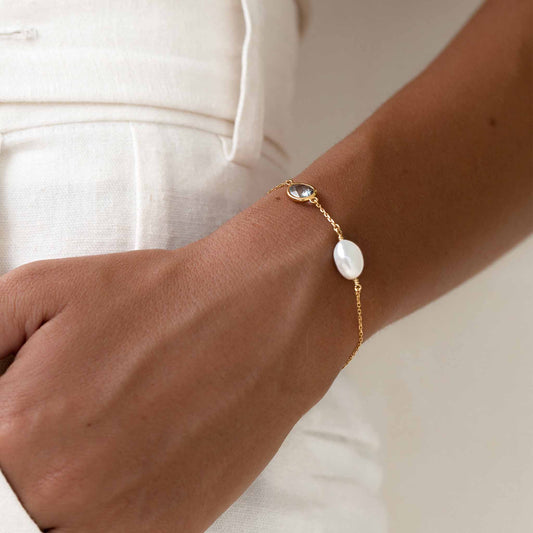 Pearl bracelet with sky blue topaz on gold vermeil chain on wrist