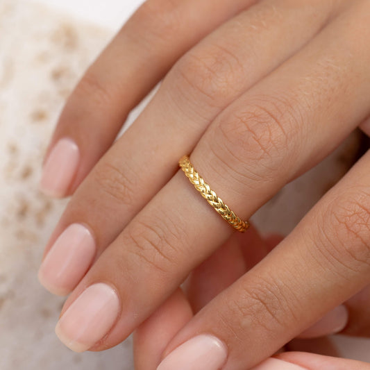 Minimalist braided gold ring on model