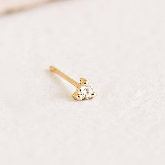 Close-up of a 14k Yellow Gold Diamond Stud Earring 2mm - Aria (Single) with a sparkling diamond on a soft background