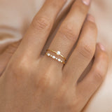 Close-up of hand wearing Marquise and Round Diamond Ring 14k Gold - Nova with delicate diamonds on a gold band