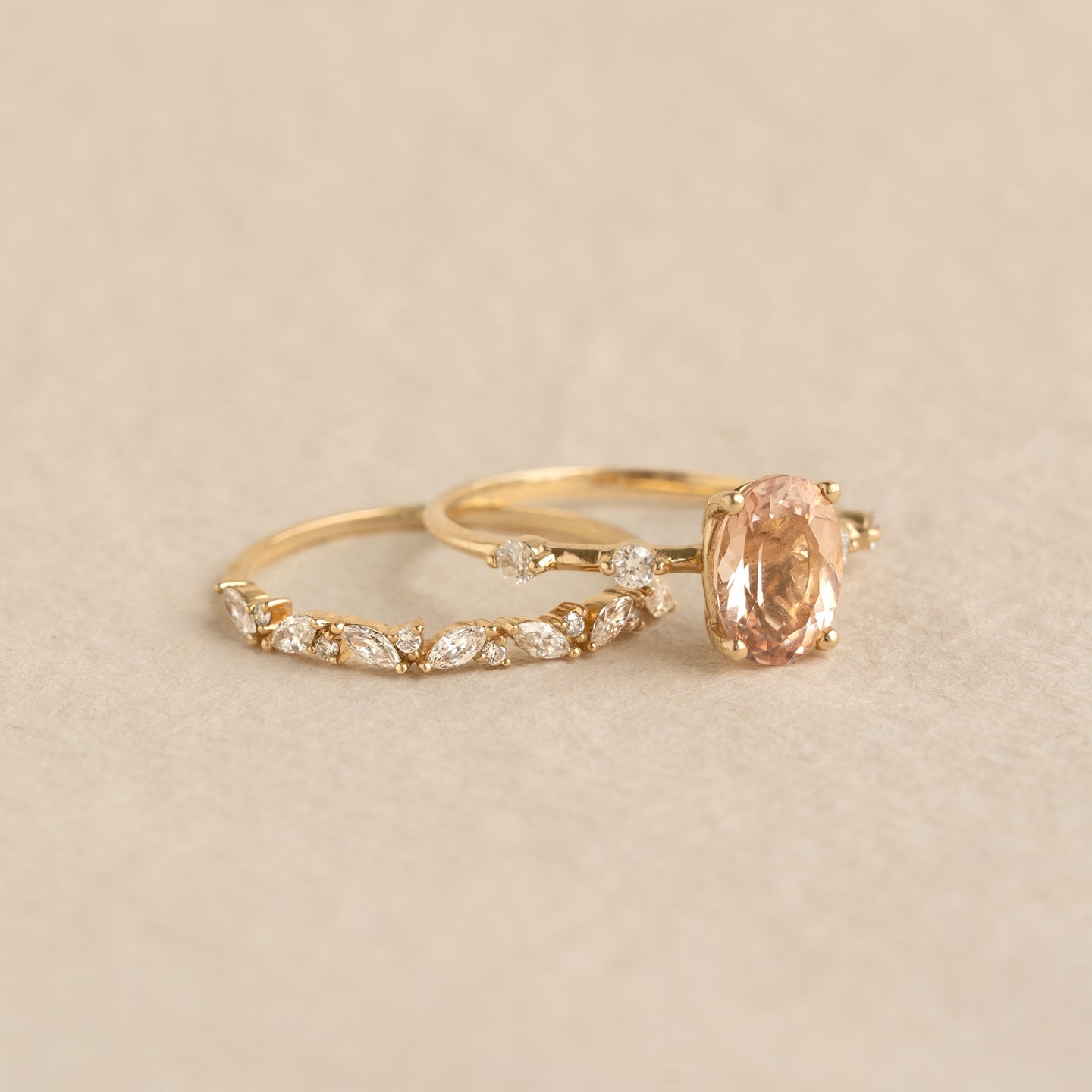 Close-up of Oval Morganite and Diamond Ring 14k Gold - Demetria with oval morganite and diamond details on beige background