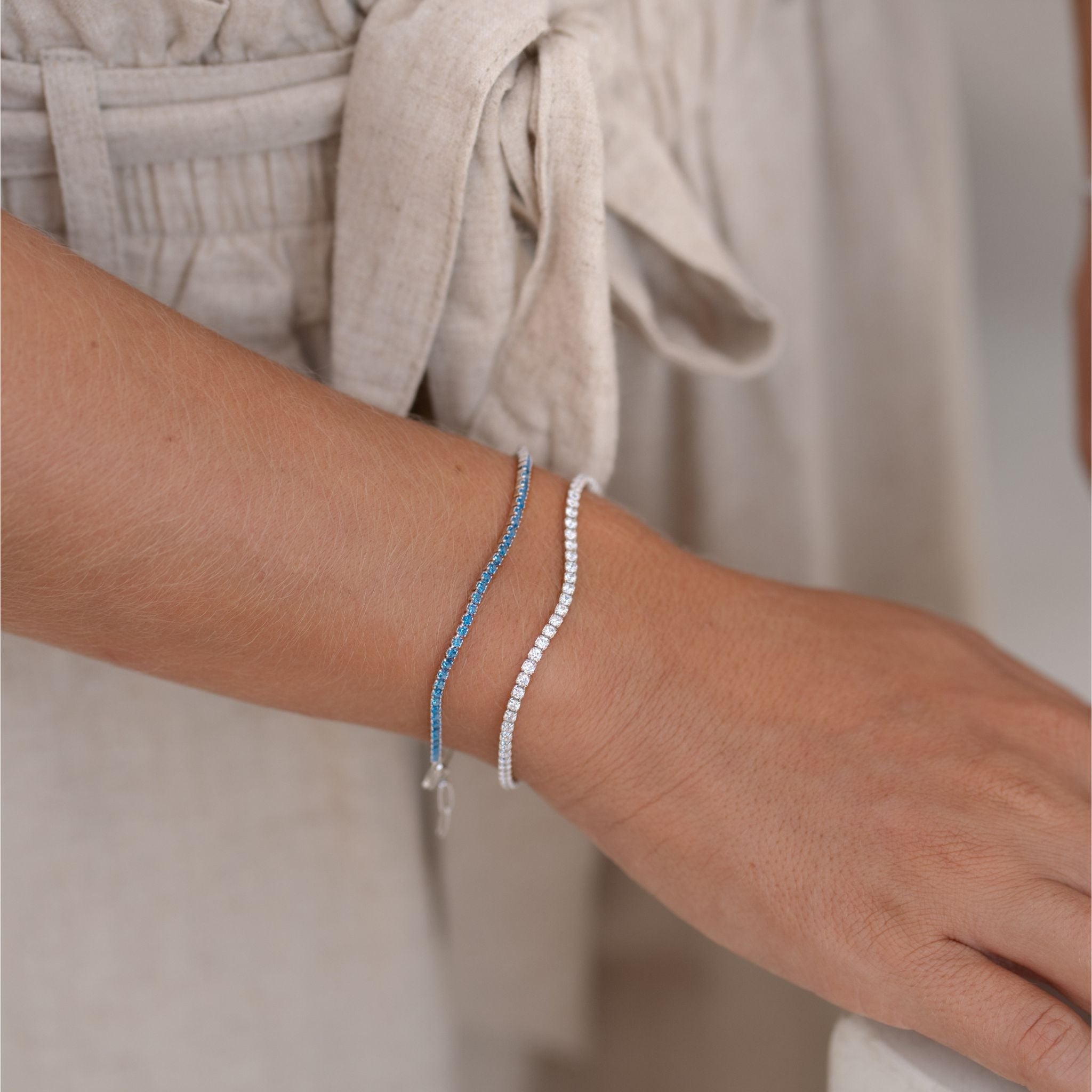 Cubic zirconia gemstone tennis bracelets on model in blue and white gemstones