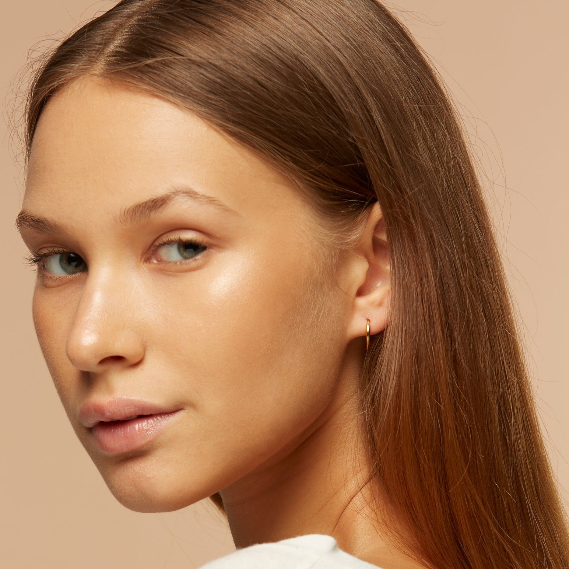 Gold vermeil huggie hoops on model