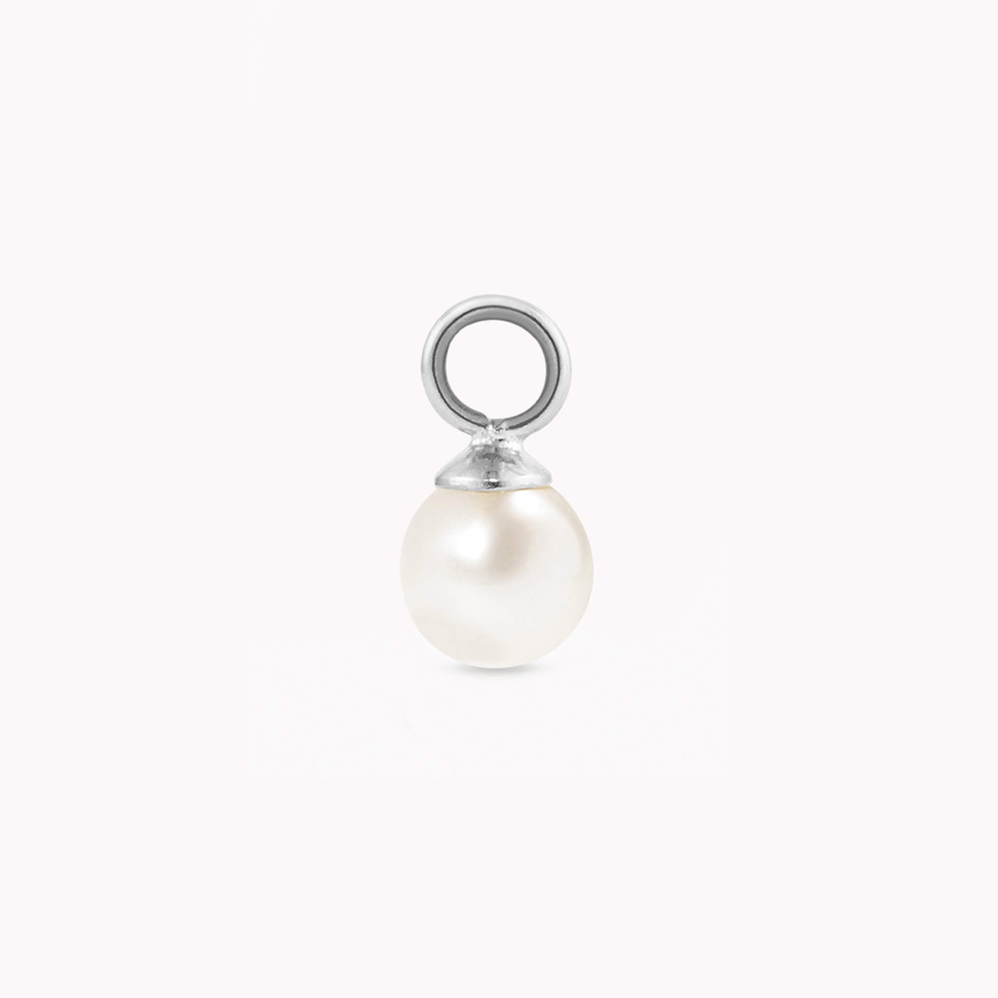 A single, luminous pearl charm with a smooth, white surface and a silver loop for attaching. The pearl exudes elegance against a plain white background.