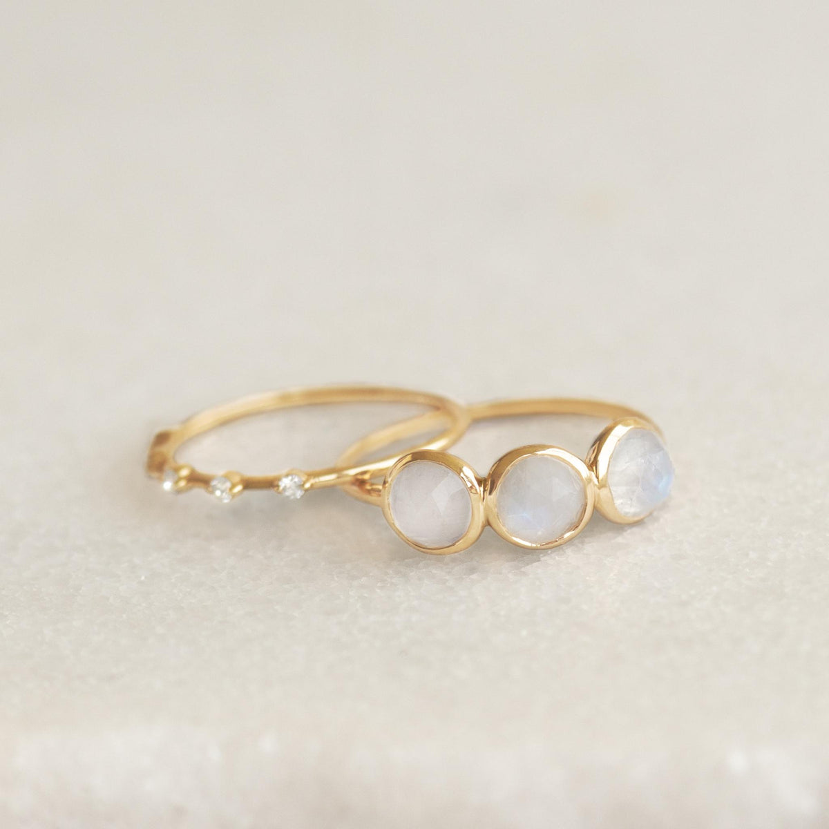 Moonstone Ring 14k Gold - Elisa with three iridescent moonstones and a delicate 14k gold band on a neutral background