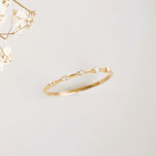 Five Stone Diamond Ring 14k Gold - Leoni featuring five small diamonds on a delicate 14k gold band on a neutral background