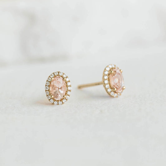 Morganite Halo Stud Earrings 14k Gold - Marzia oval-cut morganite with diamond halo on a light neutral background