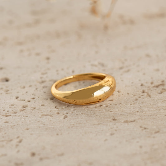 Dome Ring - Arielle statement gold vermeil ring with a puffy tapered design resting on textured stone surface