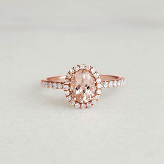 Oval Morganite Halo Ring Rose Gold - Suna featuring an oval morganite gemstone with diamond halo and pavé band on neutral background