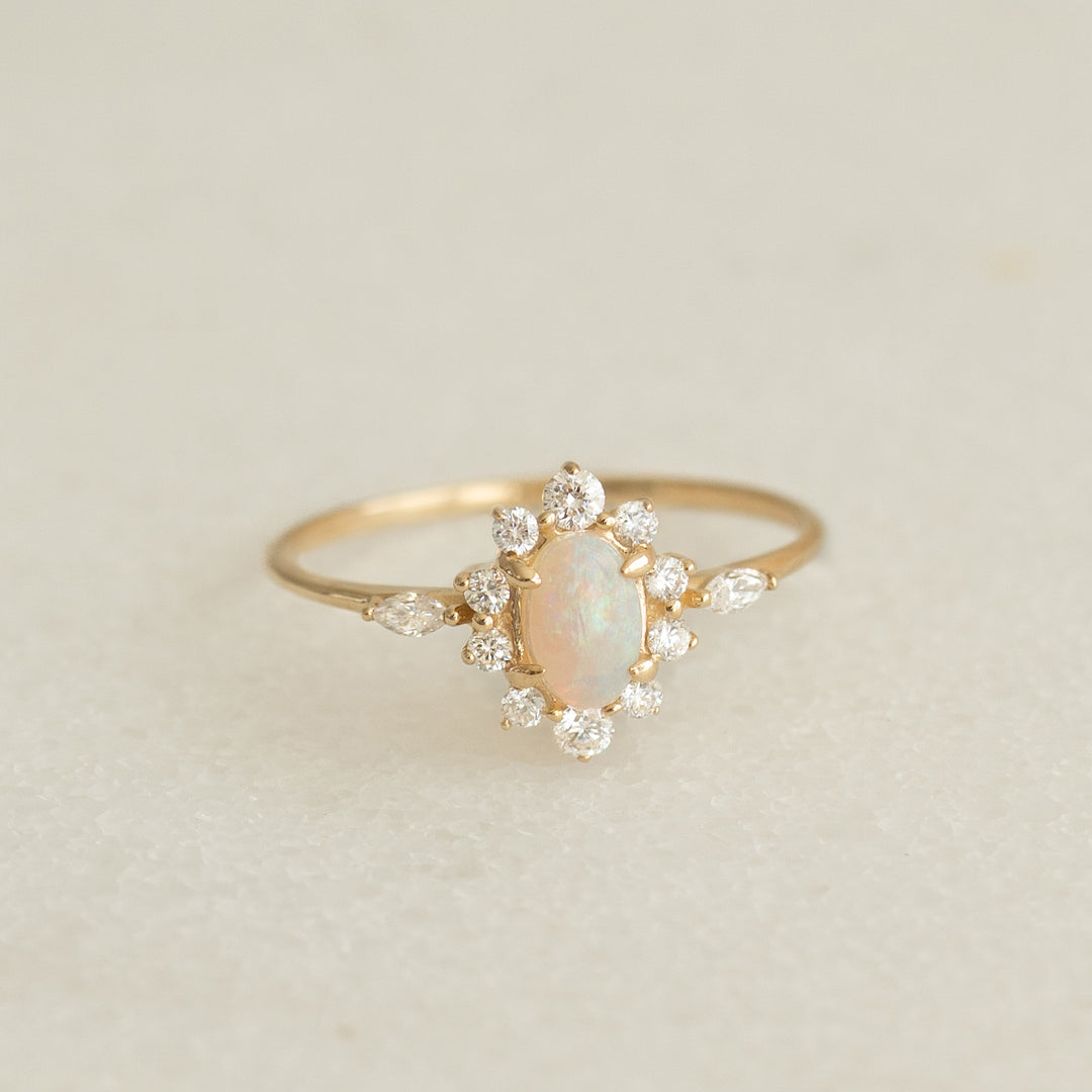 Sunburst Opal Halo Ring - Solana featuring opal cabochon and diamond halo set in 14k yellow gold on a neutral background