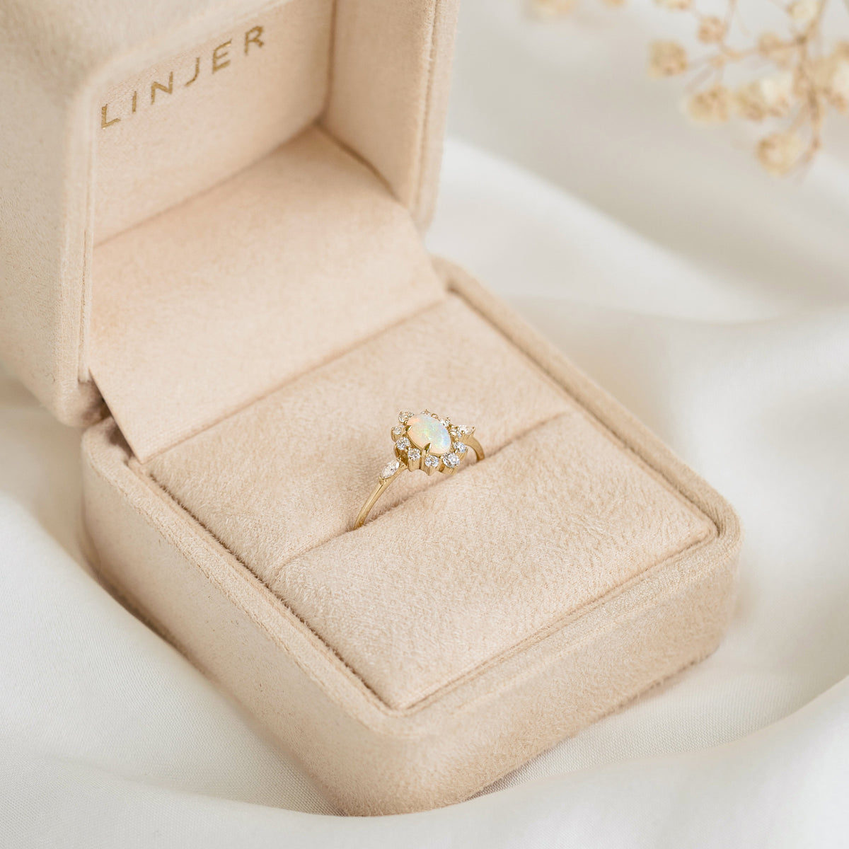 Sunburst Opal Halo Ring - Solana with opal center and diamond halo set in 14k yellow gold in a beige ring box