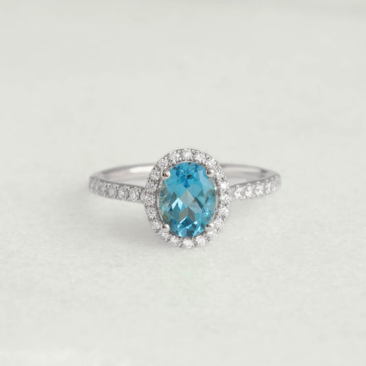 Oval Swiss Blue Topaz Halo Ring White Gold - Suna with oval blue topaz and diamond halo on white gold band