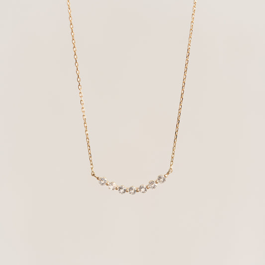 Close-up of April Birthstone Necklace 14k Gold - Diamond featuring a curved diamond bar on a delicate gold chain