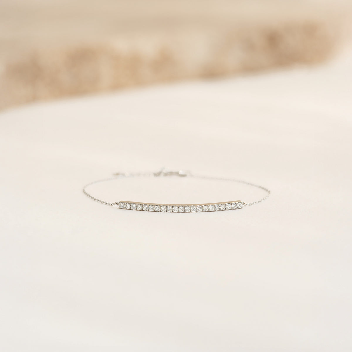 Close-up of the Diamond Curved Bar Bracelet White Gold - Vivienne featuring 21 diamonds on a delicate chain