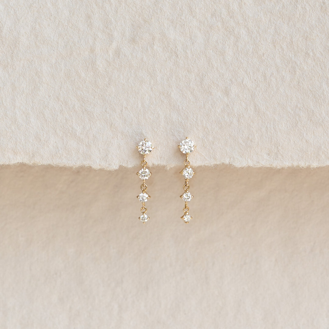 Diamond Drop Earrings 14k Gold - Helmi featuring four graduated diamonds on a delicate gold chain on neutral background