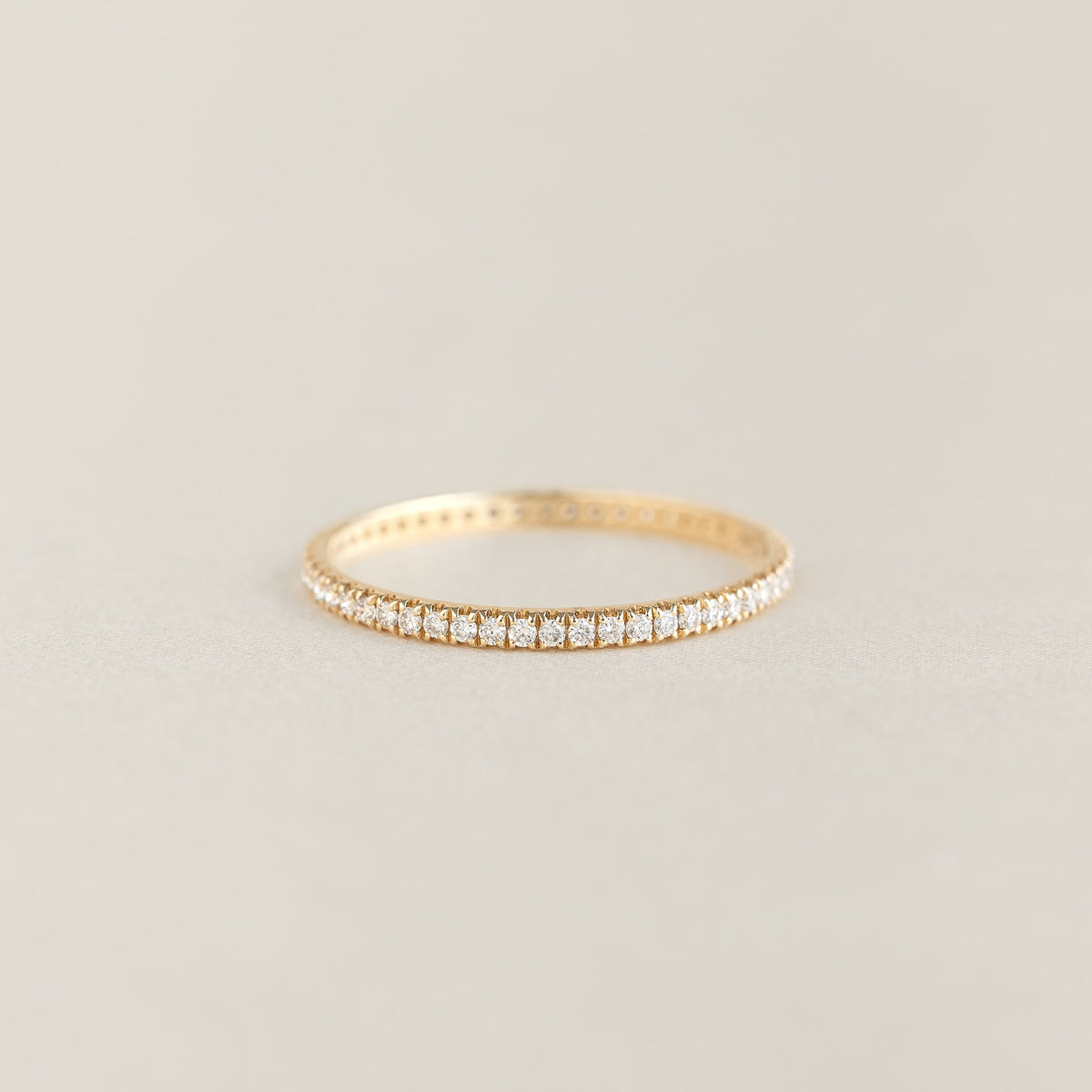 Diamond Eternity Ring in 14k yellow gold featuring a continuous row of sparkling lab-grown diamonds on a neutral background