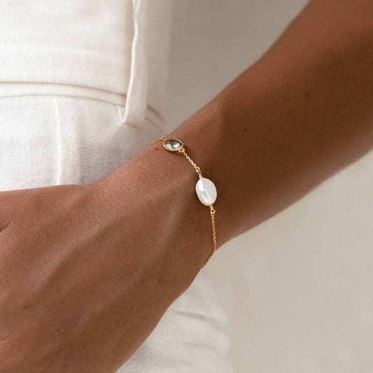 Pearl bracelet with sky blue topaz on gold vermeil chain on wrist