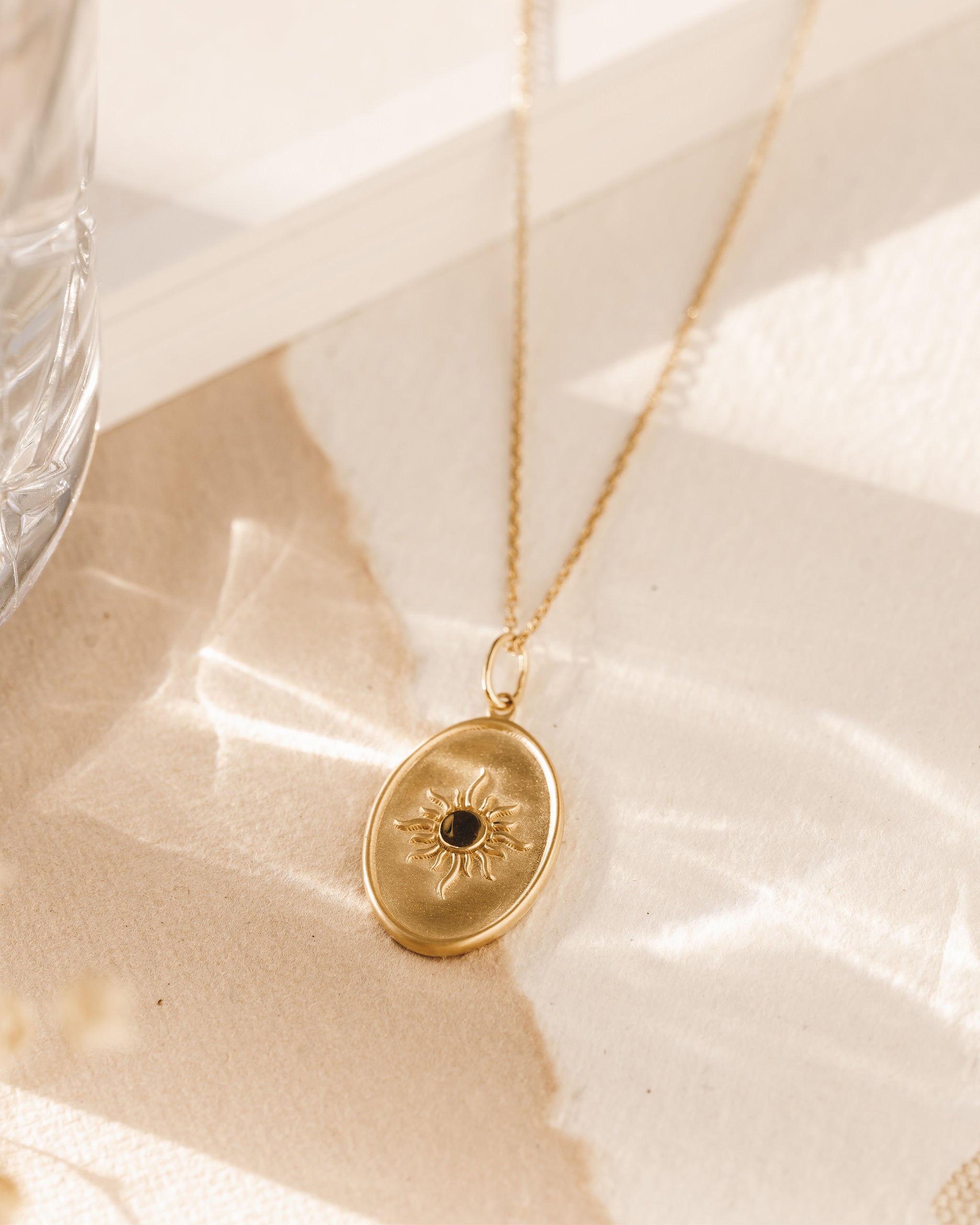 Necklace with gold sun medallion pendant