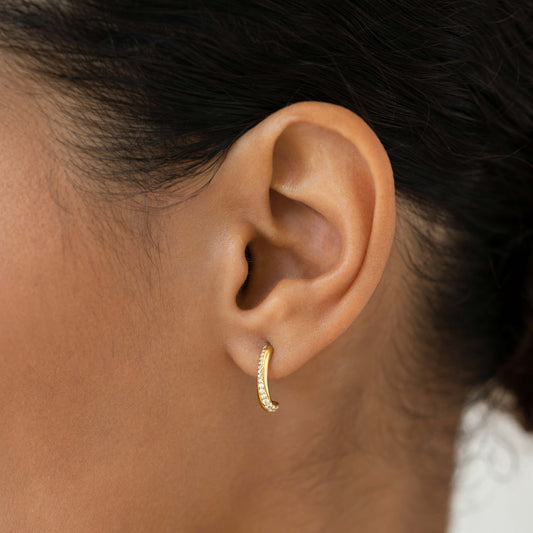 Close-up of Gemstone Double Half Hoop Earrings - Lauren worn on ear, showcasing gold vermeil and sparkling cubic zirconia stones