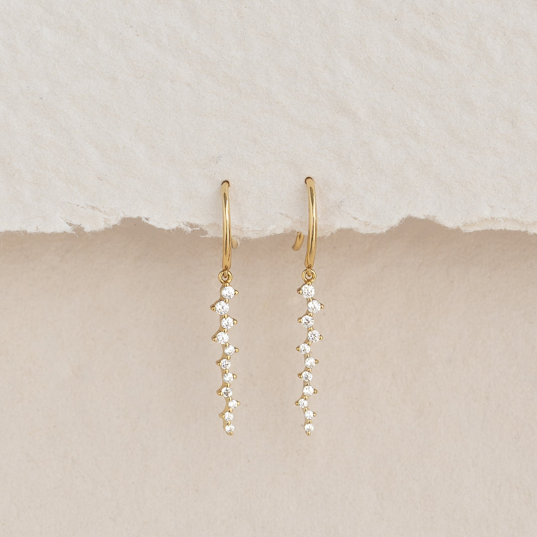 Gemstone Drop Earrings - Tamara featuring 22 cubic zirconia stones set in gold vermeil on a neutral textured background