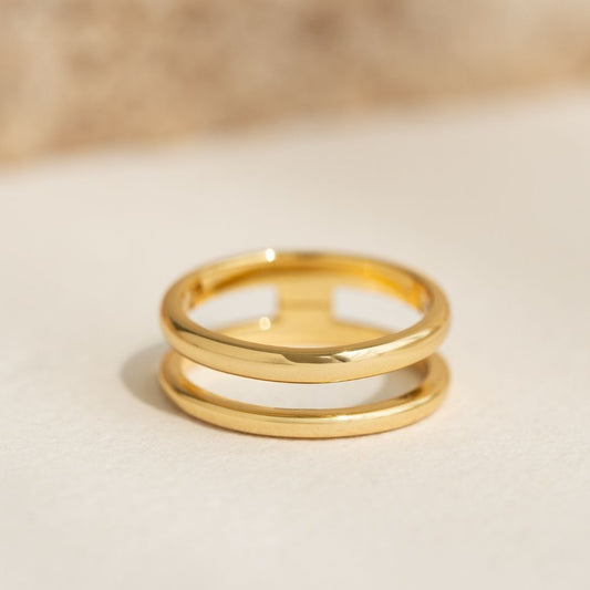 Close-up of Gold Double Band Ring - Kaija with two parallel bands in gold vermeil on a neutral background