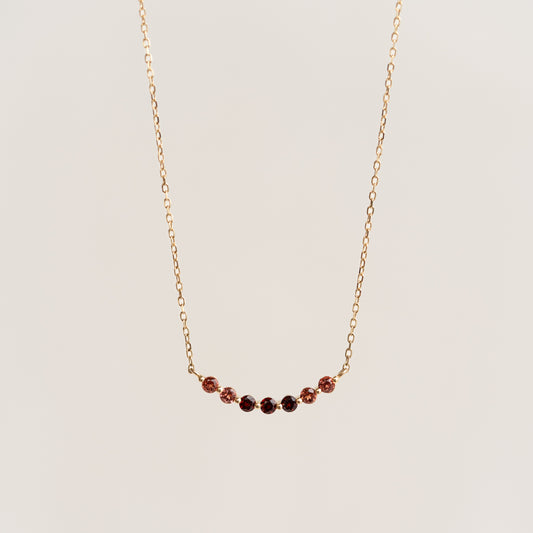 January Birthstone Necklace 14k Gold - Ombre Garnet with a delicate curved bar and gradient garnet stones on a gold chain