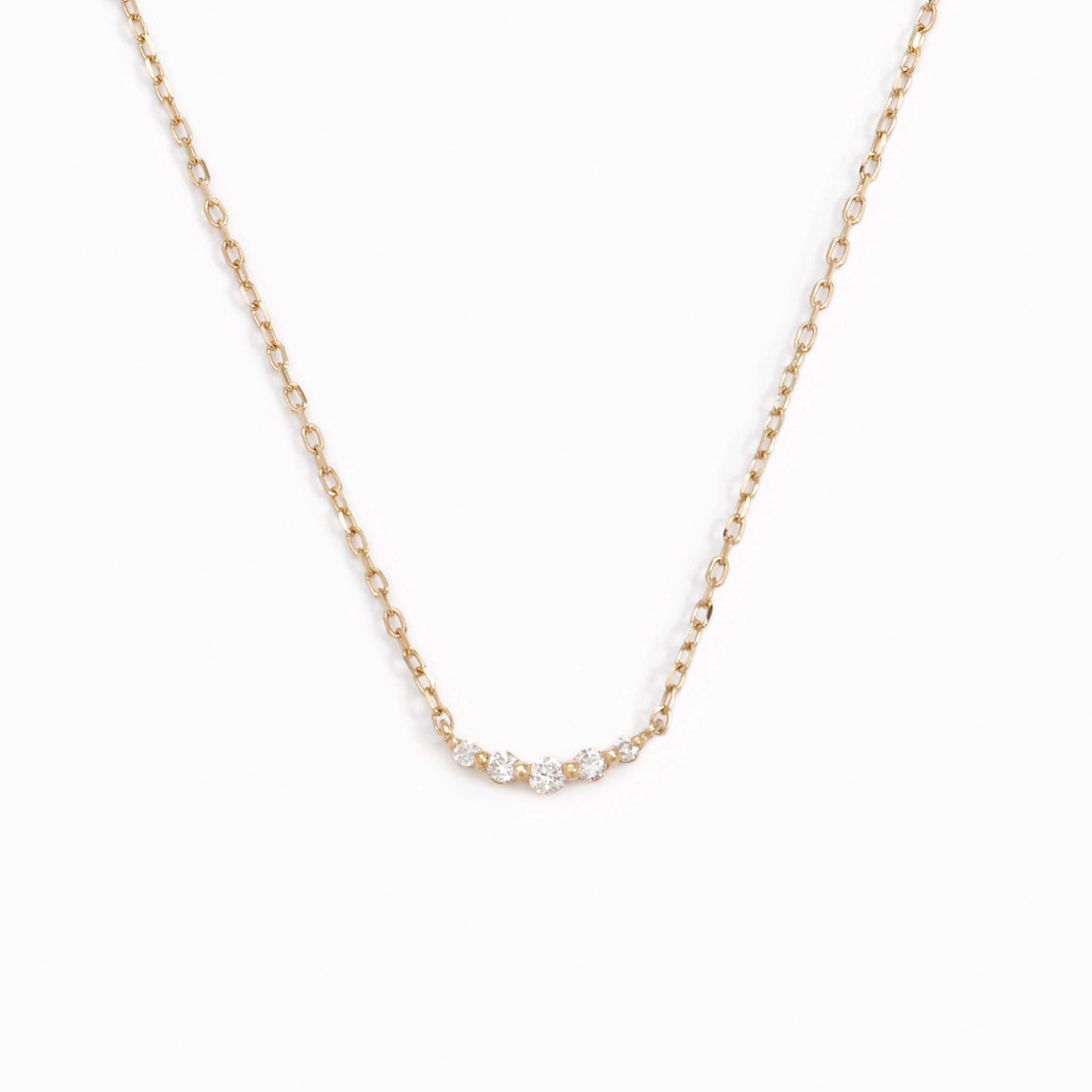 Five lab grown diamonds on a 14k yellow gold necklace chain